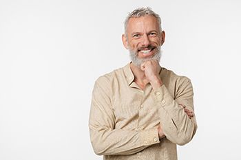 Portrait of smiling senior man who is enjoying long-term benefits of dental implants