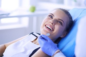 woman visiting dentist for dental implant care in Plano