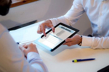 Patient reviewing dental insurance form on tablet