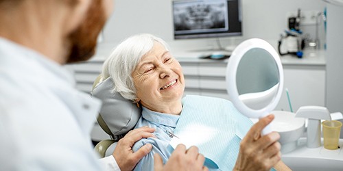 Woman in dental chair getting a restoration. 