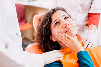 Woman with toothache in Plano visiting her Plano emergency dentist 