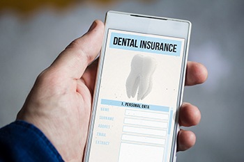 Closeup of dental insurance on patient's phone