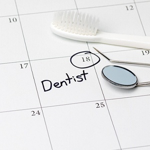 Dentist appointment circled on calendar next to dental tools