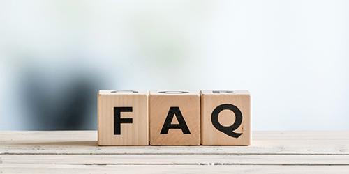 Wooden letters blocks spelling FAQ on white ledge 