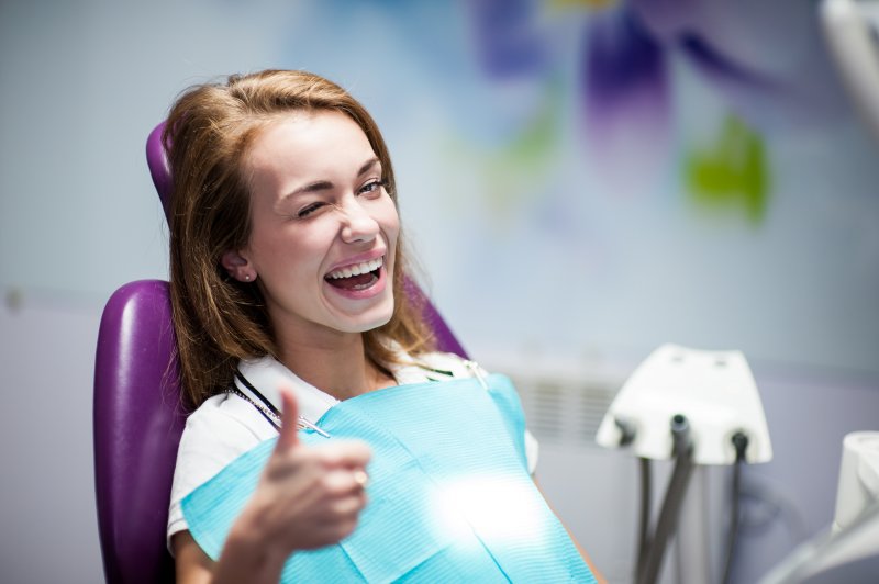woman smiling sitting in dentist chair