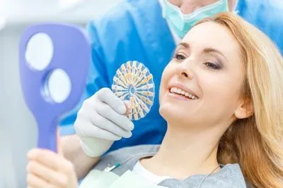 woman picking a color for her dental veneers