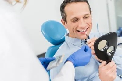 man picking a color for his dental veneers