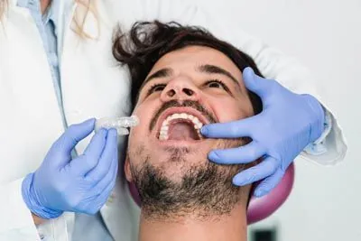 man being fitted for new Invisalign clear aligners at Parkway Vista Dental